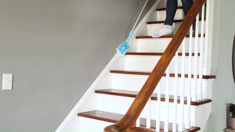 Gliding along the trim of a staircase while walking down